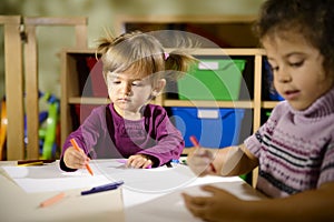 Two preschoolers drawing in kindergarten