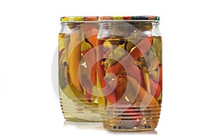 Two Preserved Pickled Chilli Peppers in Glass Jars on White Back