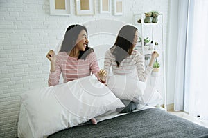 Two pretty best friends forever girlfriend talk, hug and laugh together on bed at cozy home relation fall in love. Lesbian couple