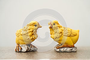 Two pretty chickens agains a light beige background with room for text.