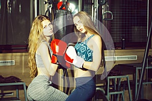 Two pretty girls boxers punching