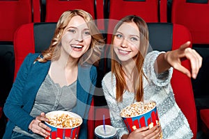 Two pretty girls in cinema