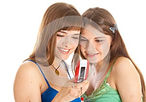 Two pretty girls reading SMS on mobile phone