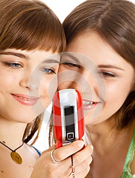 Two pretty girls reading SMS on mobile phone