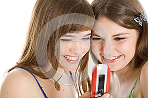 Two pretty girls reading SMS on mobile phone