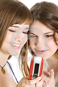 Two pretty girls reading SMS on mobile phone