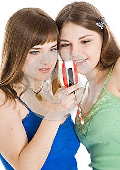 Two pretty girls reading SMS on mobile phone