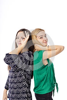 Two pretty teenage girls posing and making ok sign