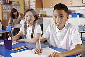 Two primary school pupils in classroom looking to camera photo