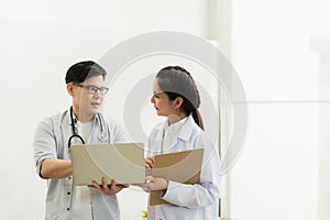 Two professional asian man and woman doctor discussing on laptop to analyse patient person