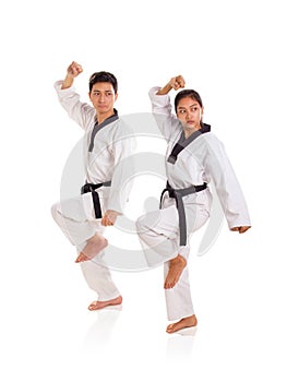 Two professional athlete showing a tae-kwon-do move