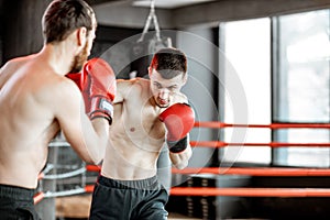 Two professional boxers fighting at the gym