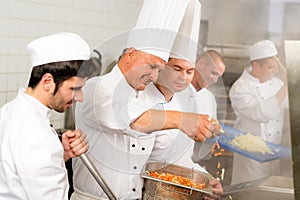 Two professional chefs cooking in kitchen