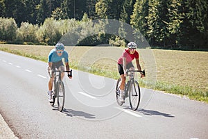 Two professional cyclist racers, male and female
