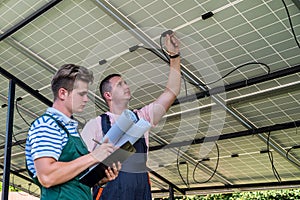 Two professional electrician checking installation solar panels