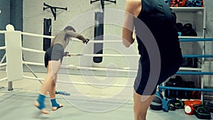 Two professional fighters are warming before sparing on the ringside.