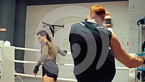 Two professional fighters are warming before training on ringside in fight club.