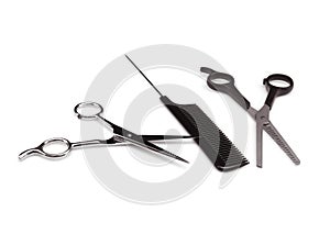 Two professional hairdresser scissors and comb