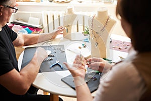 Two professional jewelers creating necklaces in their workshop