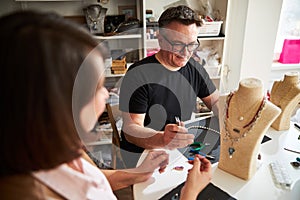 Two professional jewelers working in the workshop