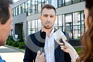 two professional journalists interviewing businessman