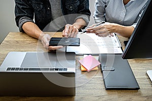 Two professional programmer cooperating and working on web site project in a software developing on desktop computer at company,