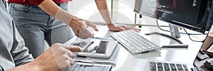 Two professional programmer cooperating and working on web site project in a software developing on desktop computer at company,