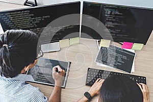 Two professional programmers cooperating at Developing programming and website working in a software develop company office, writ