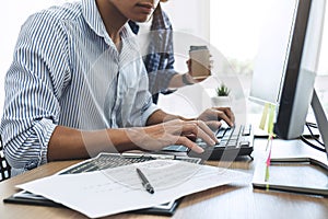 Two professional programmers cooperating at Developing programming and website working in a software develop company office,