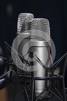 Two professional studio microphones on stands, podcasting, voiceover photo