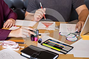 Two professional stylish fashion designer working as fashion designers measure as sketches in workshop of new collection in