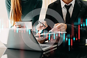 Two professional traides on technical price graph and indicator, red and green candlestick chart and stock trading computer