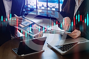 Two professional traides on technical price graph and indicator, red and green candlestick chart and stock trading computer