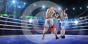 Two professionl boxers are fighting on arena