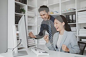 Two programmers looking at computer screen, programmer design custom computer programming, programming code and website. Computer