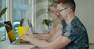 Two IT programmers are working on computer in a modern office room. Web developers working at the computer.