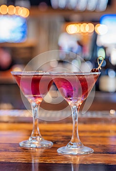 Two Purple Cocktails in Martini Glasses