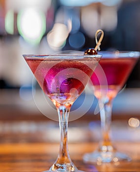 Two Purple Cocktails in Martini Glasses