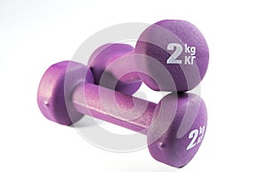 Two purple dumbells on white background