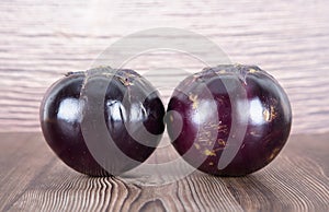 Two purple eggplants on the table