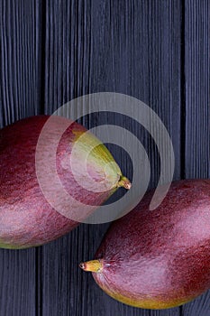 Two purple mangoes, top view.