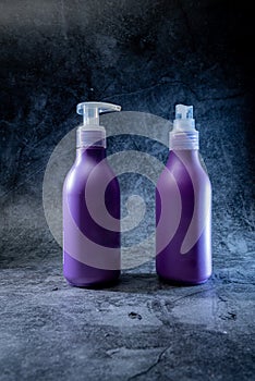 two purple plastic bottles from chemical cleaning