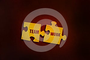 Two puzzle peaces with words Team Work almost connected together. Team building teamwork collaboration business process concept