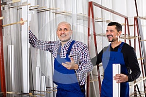 Two PVC industry workers in coveralls