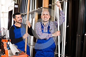 Two PVC industry workers in coveralls