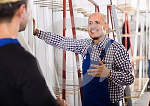 Two PVC industry workers in coveralls