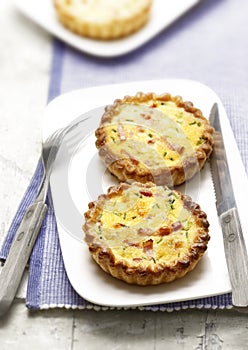 Two quiches with bacon on a plate