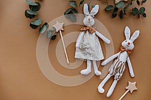 Two rabbits with wooden toys  on brown background.