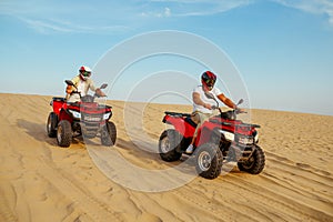 Two racers coming down from the dunes on atv