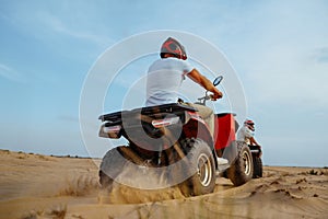 Two racers in helmets ride on atv, action view